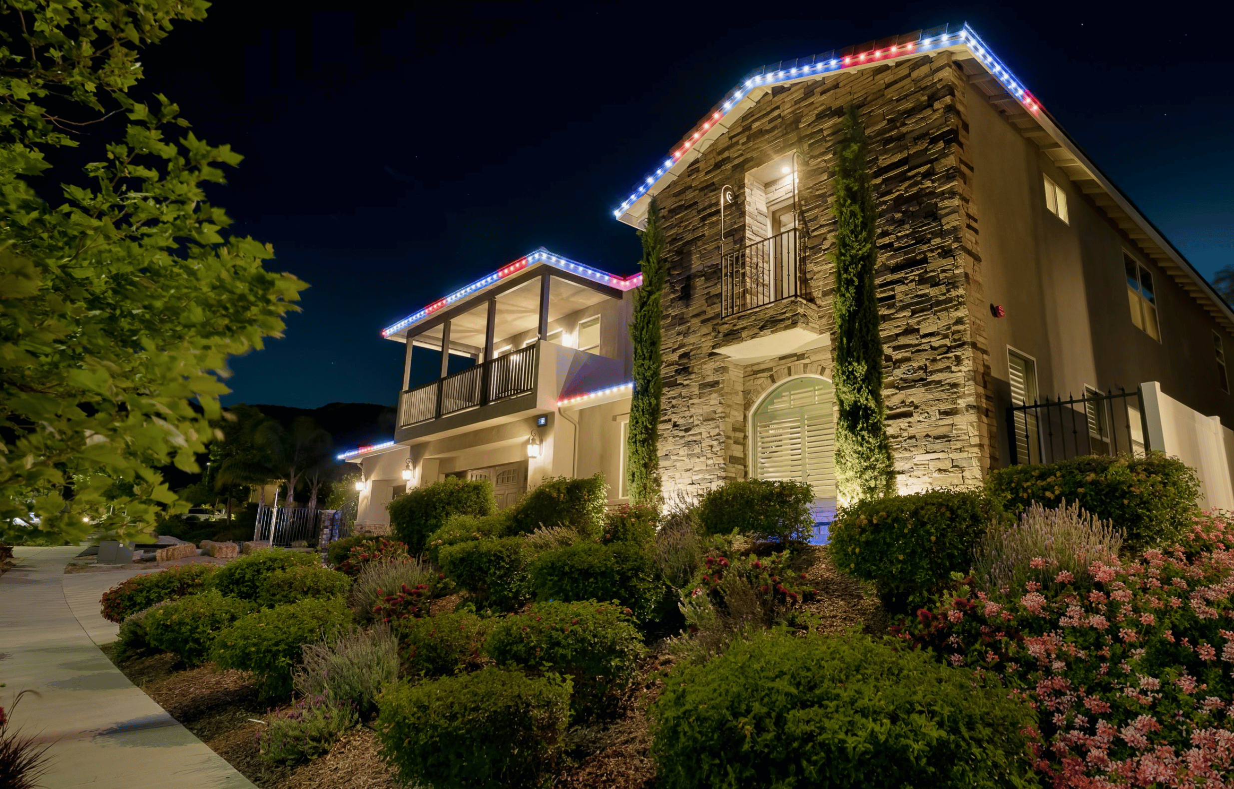Custom home after outdoor lighting by Starry Night Lights