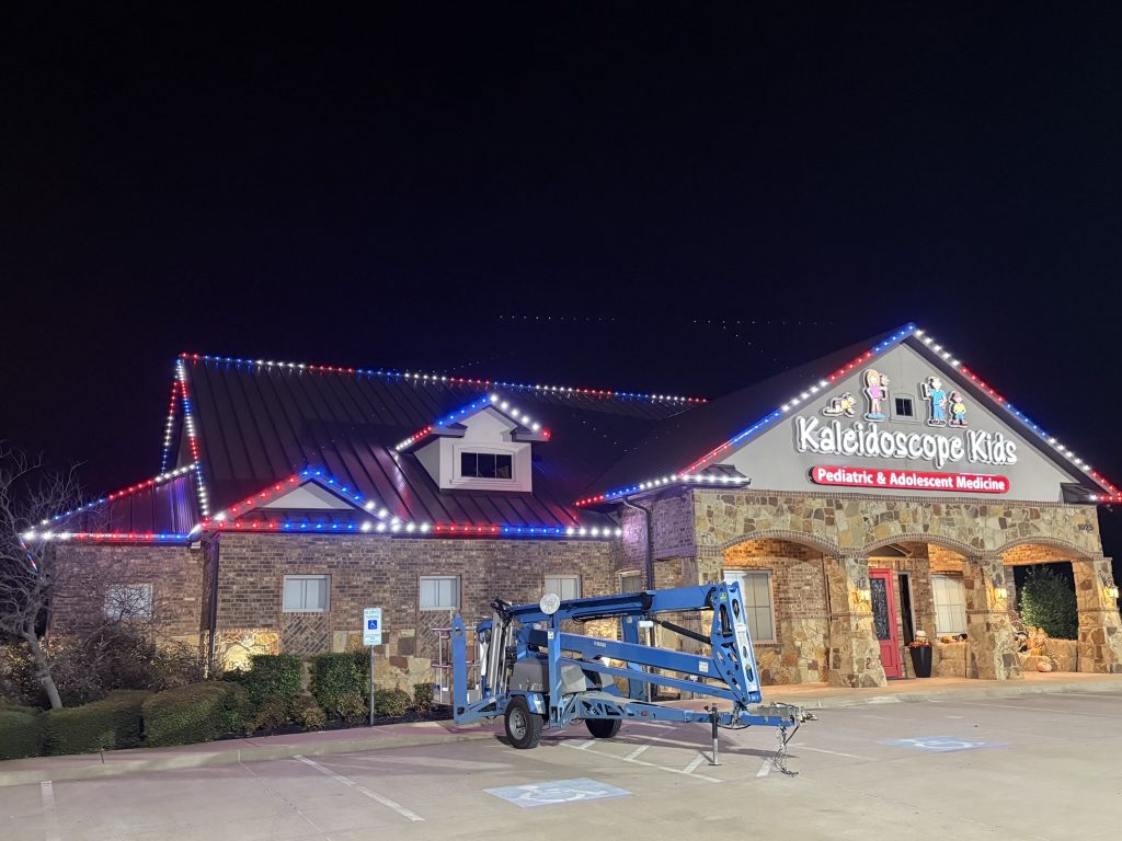 Stand alone office building outlined with red white and blue LED roofline lights