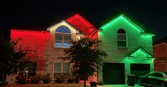 red-green-white color washes the exterior of two story home